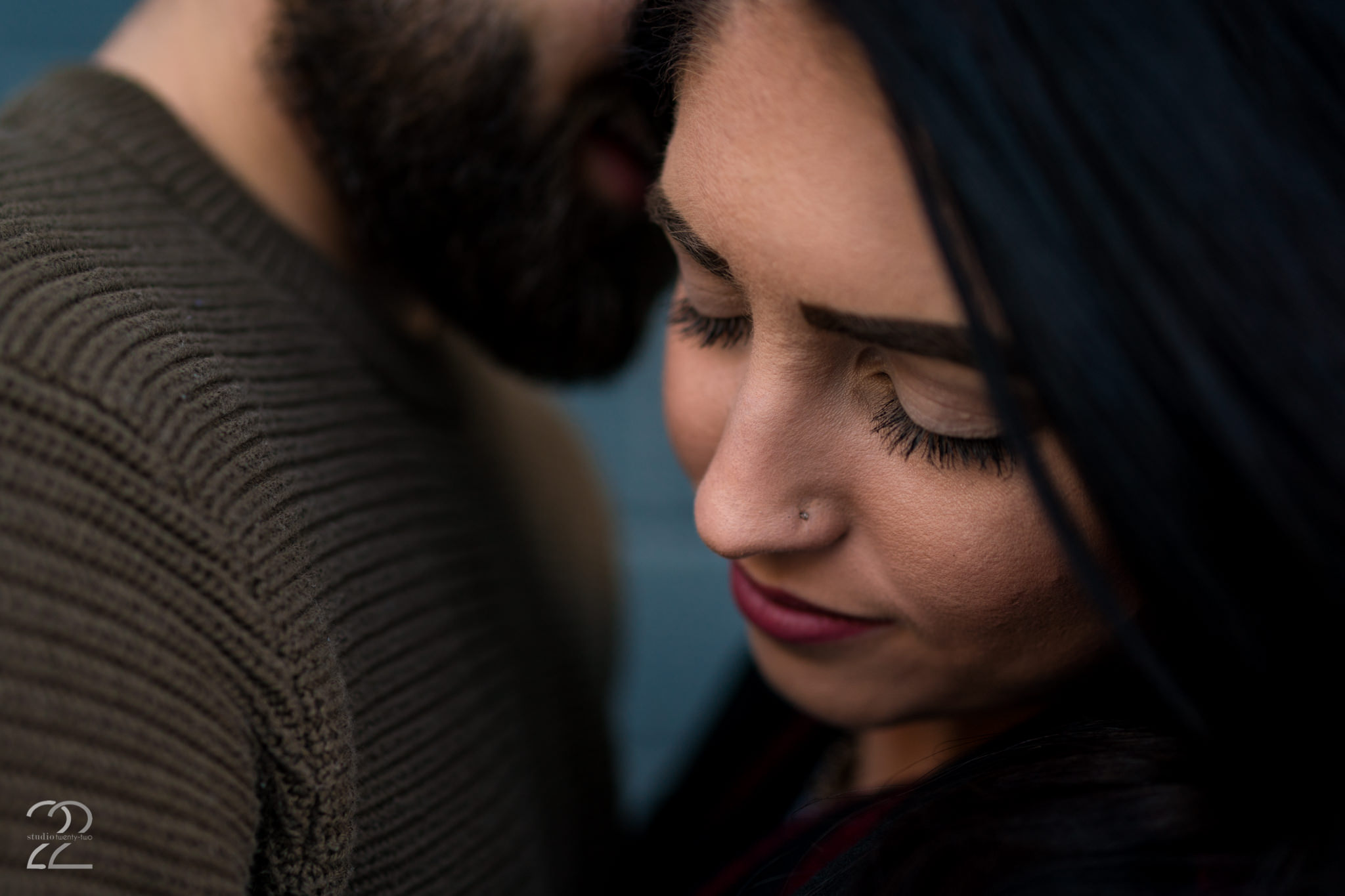 Up close photo of a man whispering in a woman's ear in Downtown Dayton by Dayton Wedding Photographer Studio 22 Photography